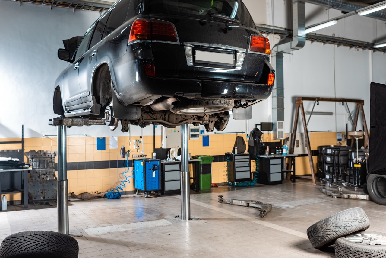Black SUV on a lift in the workshop